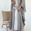 A closer view of the lower part of the Lexus Ensemble Vollkommenheit abaya, showcasing the light brown exterior, matching shoes, and a silver bag for a cohesive and elegant look.