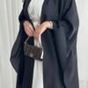 A detailed view of the Lexus Krepp-Ensemble Elegance Plus abaya, showcasing its balanced beige tone, elegant design, and jewelry accents.