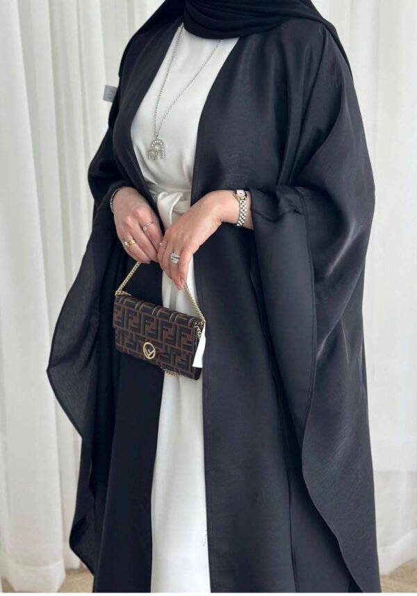 A detailed view of the Lexus Krepp-Ensemble Elegance Plus abaya, showcasing its balanced beige tone, elegant design, and jewelry accents.
