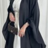 : A closer look at the Lexus Krepp-Ensemble Elegance Plus abaya in a balanced beige/white tone, paired with jewelry and a Fendi bag, highlighting its refined and seamless design.