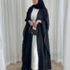 A lady wearing the Lexus Krepp-Ensemble Elegance Plus abaya, featuring a white interior with a black exterior, accessorized with jewelry and a Fendi bag, exuding refined elegance.