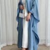A closer view of the Luxus Lexus-Ensemble Royal abaya, showcasing the light beige and white interior, light blue exterior, and elegant shoes, emphasizing the lower part of the outfit.