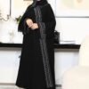 A young lady wearing the Premium Krepp-Abaya Tradition, a black abaya with elegant border patterns, showcasing timeless style and sophistication.
